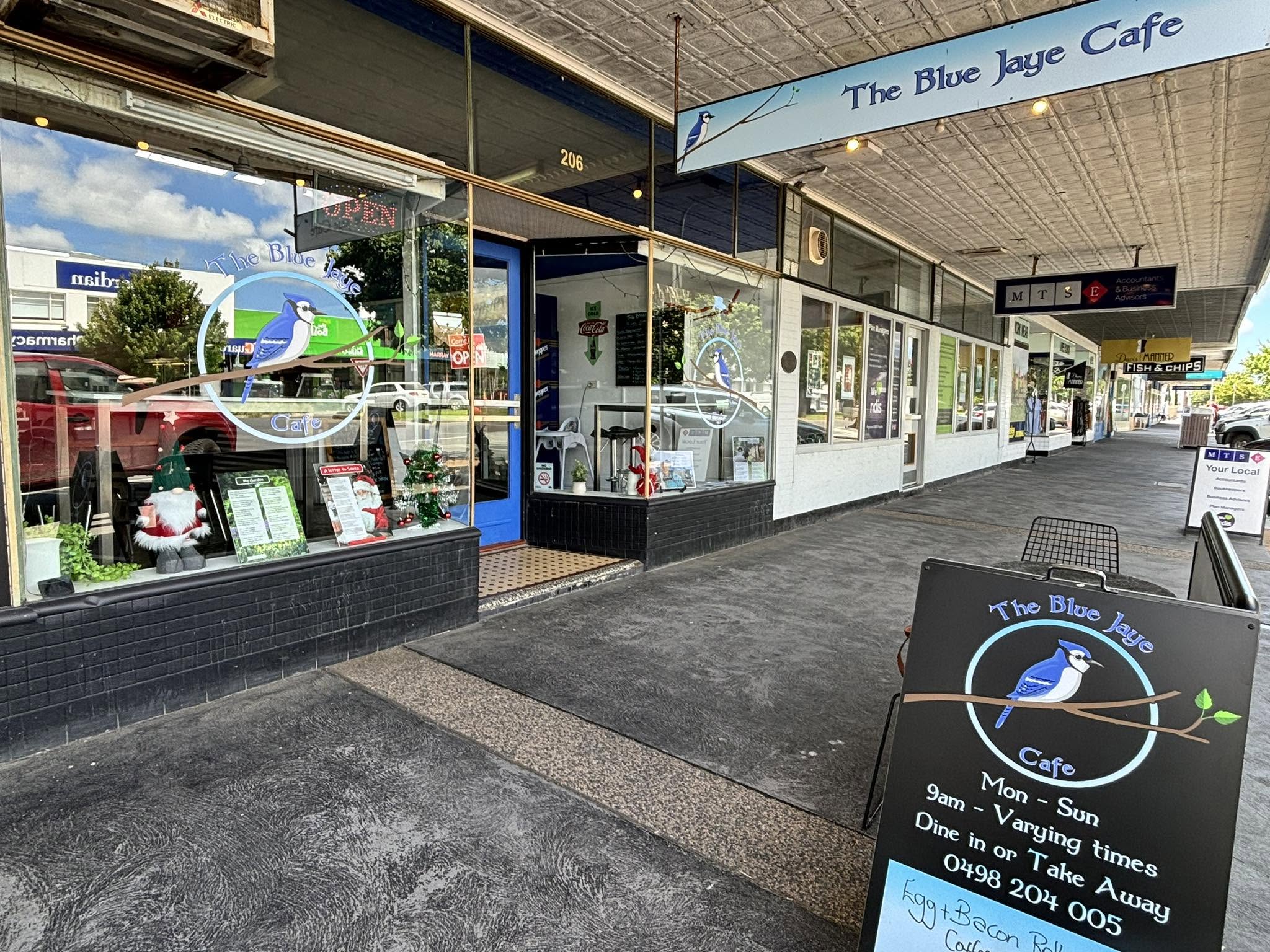 The Blue Jaye Cafe shopfront on Commercial Road, Yarram, with the blue jay sign in the window and the sandwich board out front