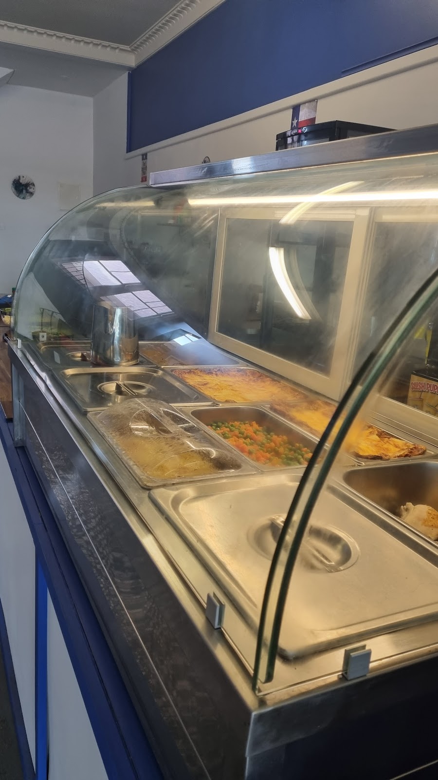 The glass hot food cabinet inside the cafe