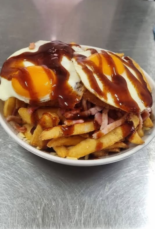 The Texas breakfast: chips, bacon and cheese topped with two fried eggs and house BBQ sauce